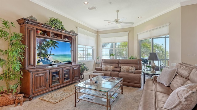 living room with crown molding, light colored carpet, and ceiling fan