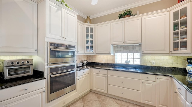 kitchen featuring ornamental molding, white cabinetry, and light tile patterned flooring