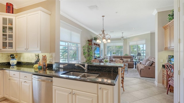 kitchen with kitchen peninsula, sink, and plenty of natural light