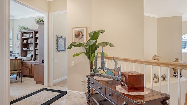 corridor with crown molding and light tile patterned floors