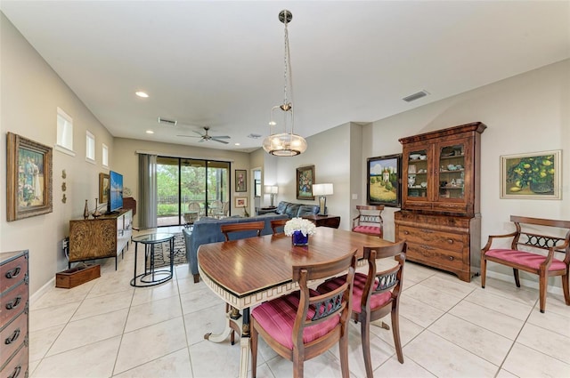 tiled dining space featuring ceiling fan