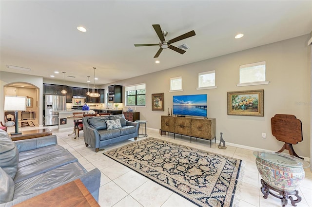 tiled living room with ceiling fan