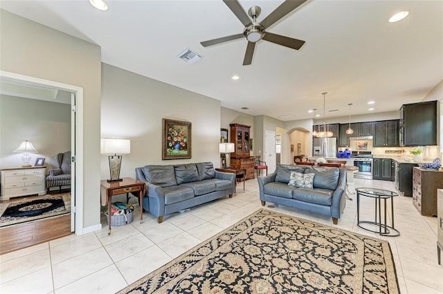 living room with light tile patterned flooring and ceiling fan