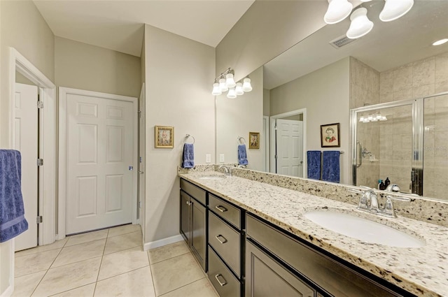 bathroom featuring tile patterned flooring, vanity, and an enclosed shower