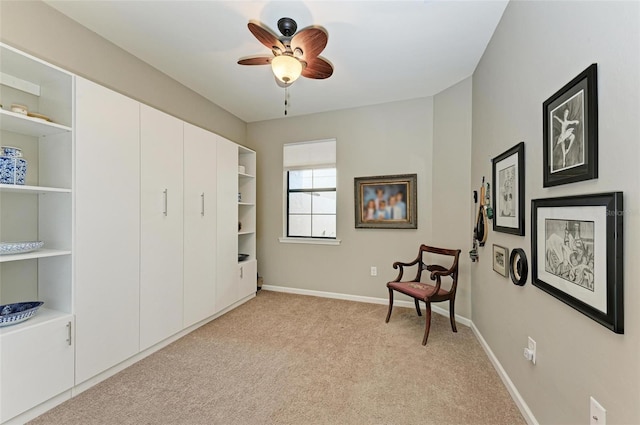 sitting room with light colored carpet and ceiling fan