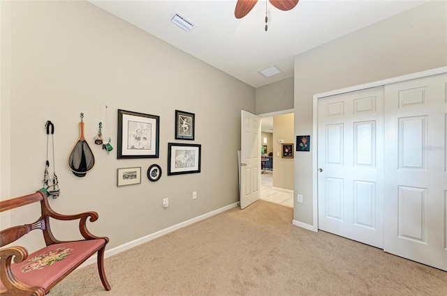 sitting room featuring ceiling fan and light colored carpet