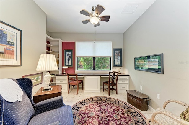 sitting room with built in desk, ceiling fan, and light tile patterned floors