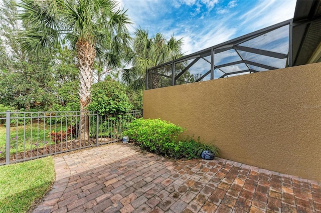 view of patio featuring a lanai