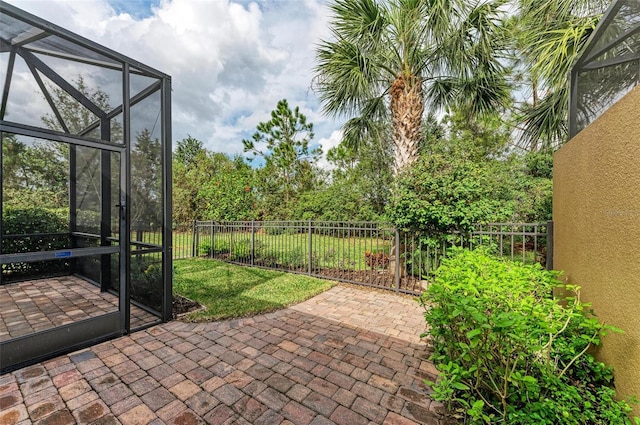 view of patio featuring glass enclosure