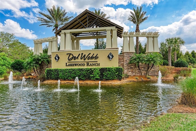 community / neighborhood sign featuring a water view