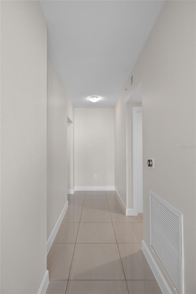 corridor with light tile patterned flooring