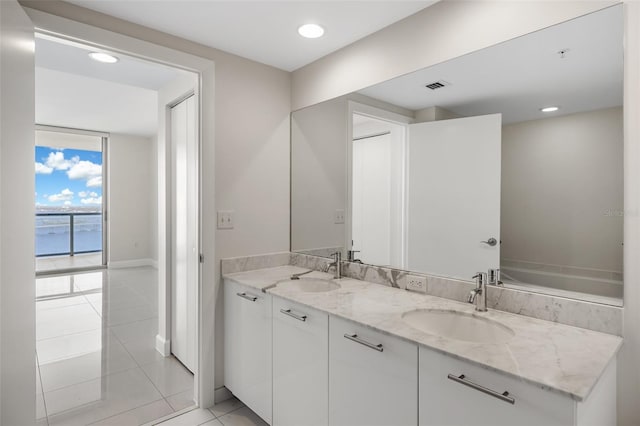 bathroom with vanity, tile patterned floors, and a water view