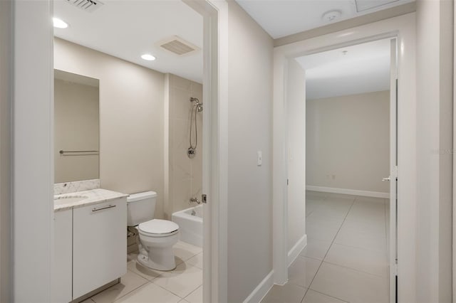 full bathroom featuring vanity, tiled shower / bath combo, toilet, and tile patterned flooring