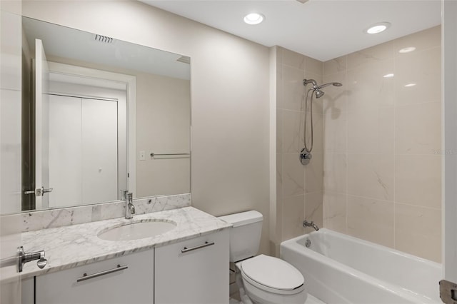 full bathroom featuring vanity, toilet, and tiled shower / bath