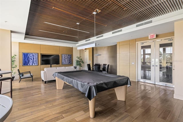 playroom featuring light hardwood / wood-style floors, french doors, billiards, and a tray ceiling