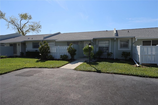 4105 33rd Avenue Dr W Unit 4105, Bradenton, FL 34205 - single story home with a front yard, roof with shingles, fence private yard, and stucco siding