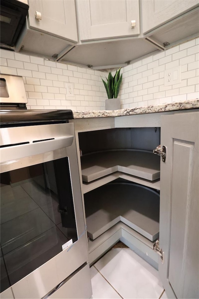 4105 33rd Avenue Dr W Unit 4105, Bradenton, FL 34205 - room details with electric stove, light stone counters, ventilation hood, and decorative backsplash