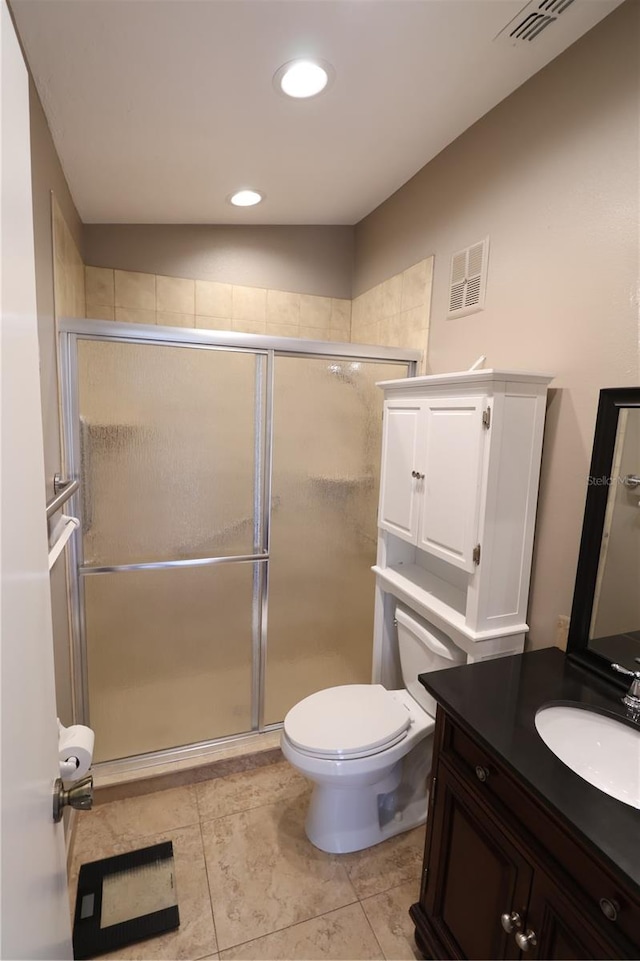 bathroom featuring a shower with door, vaulted ceiling, toilet, vanity, and tile patterned flooring