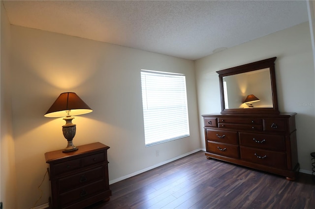 4105 33rd Avenue Dr W Unit 4105, Bradenton, FL 34205 - bedroom with a textured ceiling, dark wood-style flooring, and baseboards