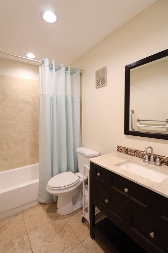 full bathroom with vanity, shower / tub combo with curtain, toilet, and tile patterned flooring