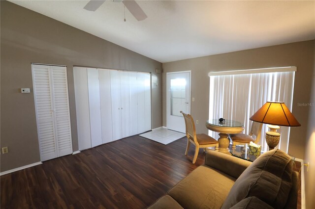 living room with vaulted ceiling, hardwood / wood-style flooring, and ceiling fan