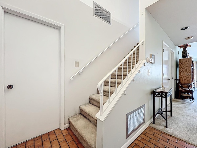 stairway featuring carpet flooring