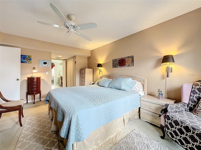 bedroom featuring a textured ceiling, carpet flooring, and ceiling fan