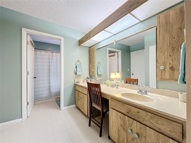 bathroom featuring vanity, a textured ceiling, curtained shower, and tile patterned floors