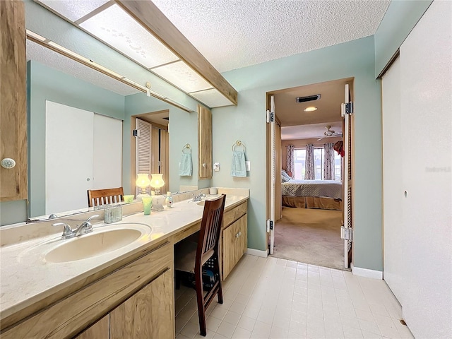 bathroom with vanity, tile patterned floors, and a textured ceiling