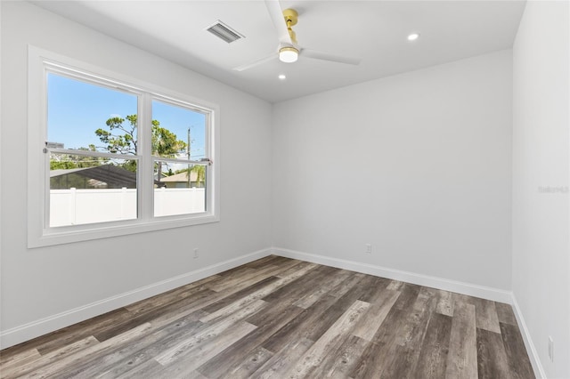 empty room featuring dark wood-type flooring and ceiling fan