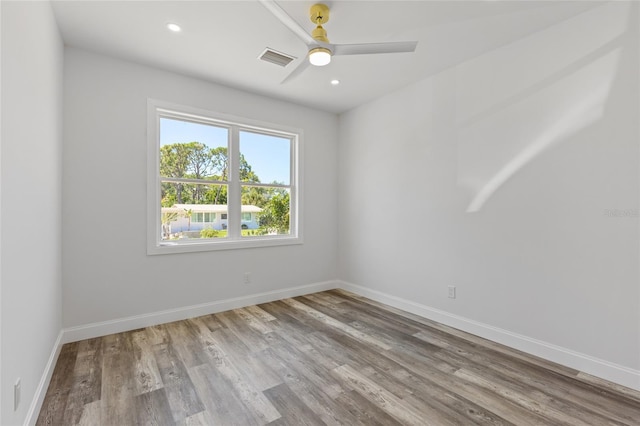 spare room with wood-type flooring and ceiling fan