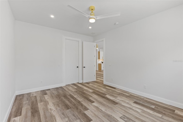 spare room featuring light hardwood / wood-style floors and ceiling fan