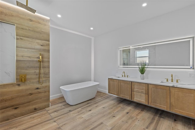 bathroom featuring vanity, ornamental molding, independent shower and bath, and wood-type flooring