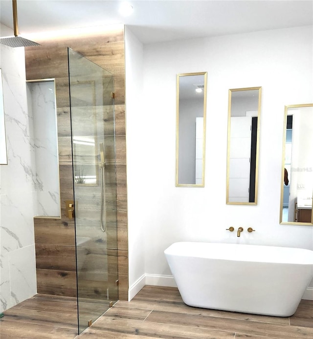 bathroom featuring hardwood / wood-style flooring and separate shower and tub