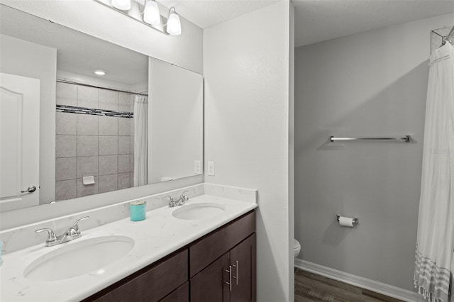 bathroom featuring vanity, a shower with curtain, hardwood / wood-style flooring, and toilet