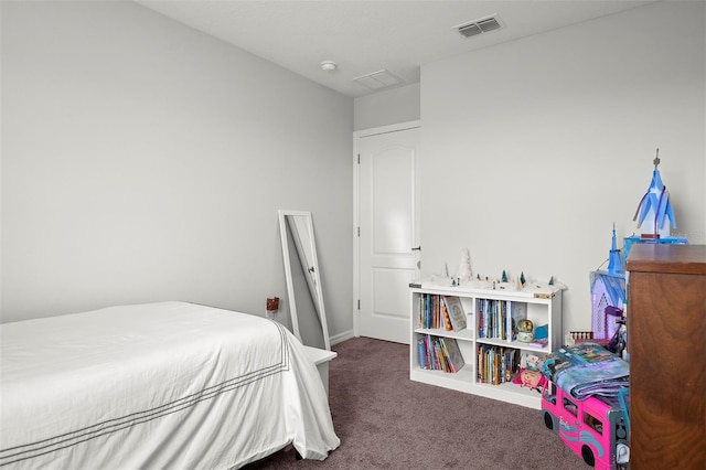 bedroom with dark colored carpet