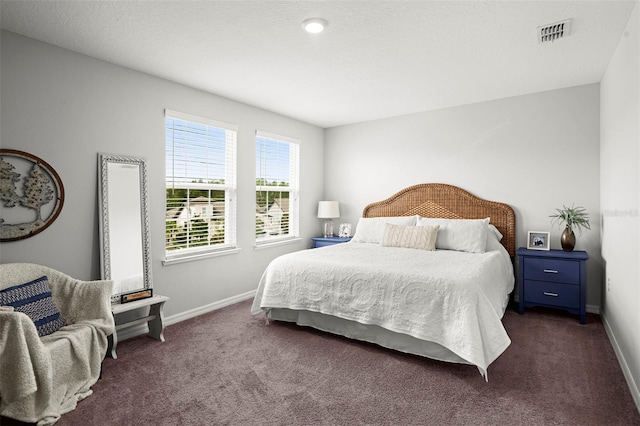 bedroom with dark colored carpet