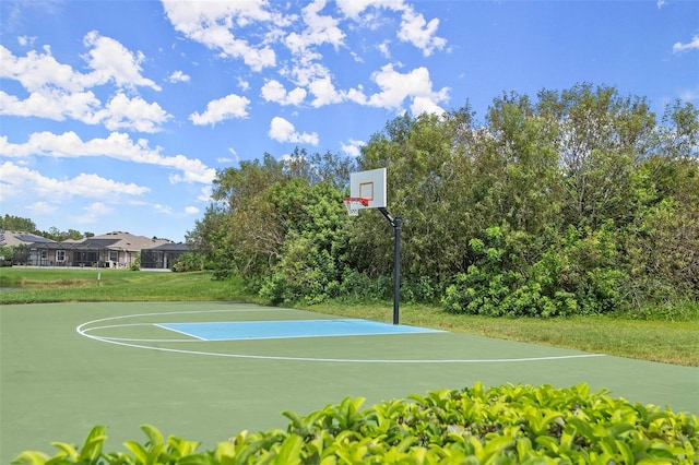 view of basketball court with a lawn