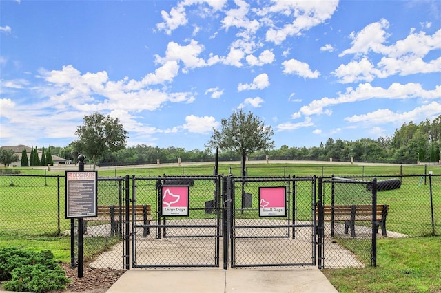 view of gate with a lawn