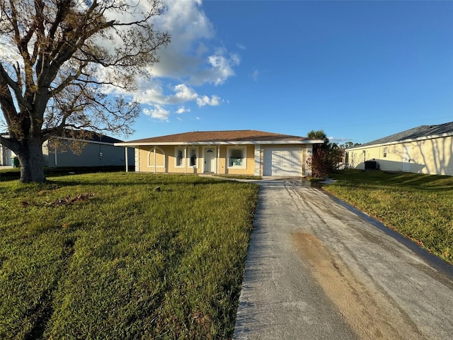 ranch-style house with a garage and a front lawn