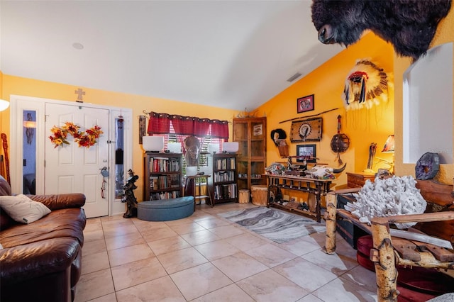 living room with light tile patterned flooring and vaulted ceiling