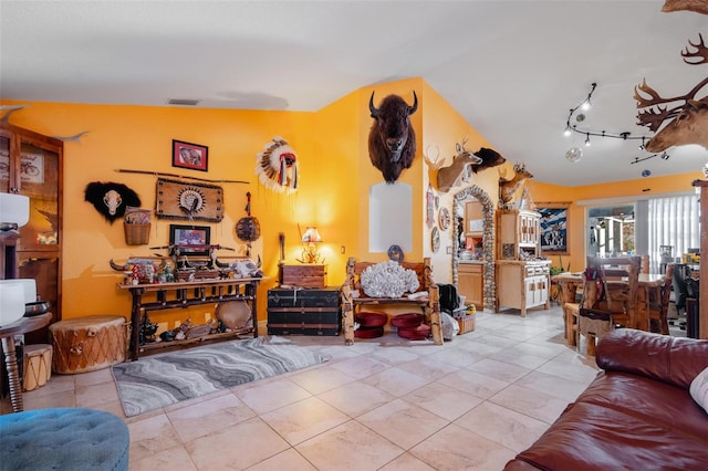 living room featuring light tile patterned floors and lofted ceiling