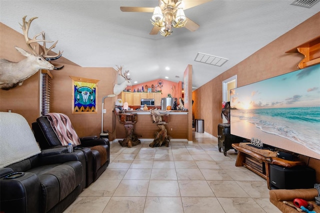 tiled living room with vaulted ceiling, a textured ceiling, and ceiling fan