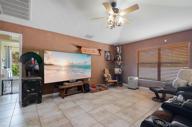 tiled living room with lofted ceiling and ceiling fan