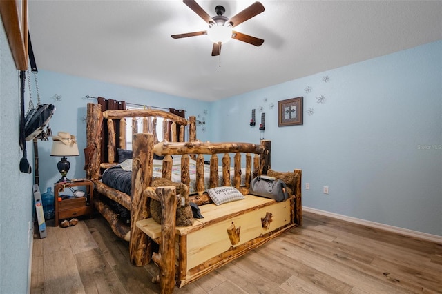 bedroom with ceiling fan and hardwood / wood-style flooring