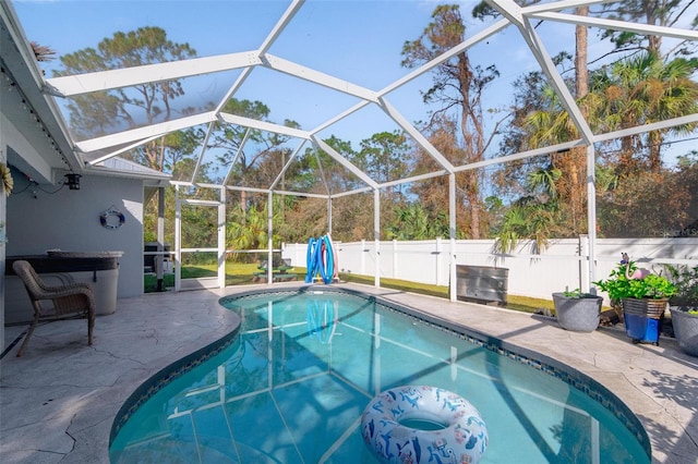 view of pool with a patio area and a lanai