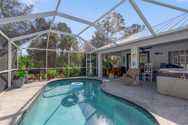 view of pool featuring a patio, ceiling fan, and glass enclosure