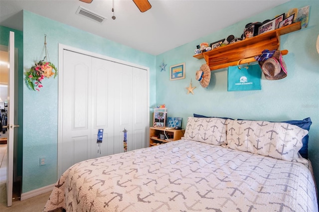 carpeted bedroom featuring a closet and ceiling fan