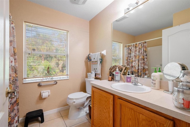 bathroom featuring vanity, toilet, and tile patterned floors