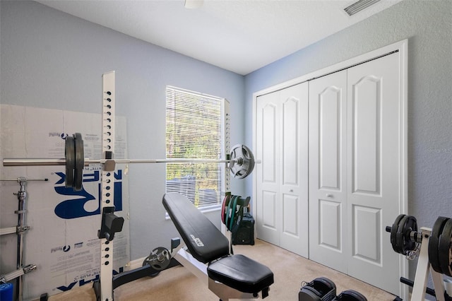 workout area featuring light colored carpet